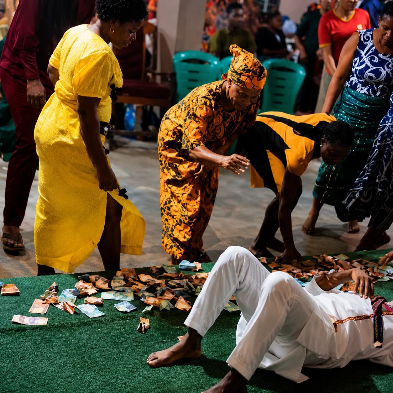 Nigerian pastor instructing worshippers to drop money on the floor during a church service.